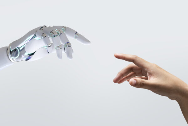 Robot hand reaching towards a human hand. AI transformation concept.